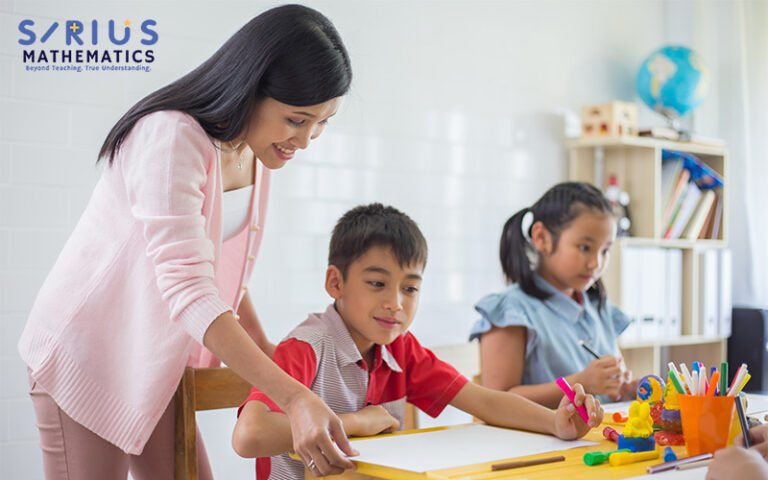 Teacher guiding students at Sirius Mathematics tuition.