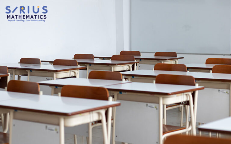 Empty Sirius Mathematics classroom with desks and whiteboard.