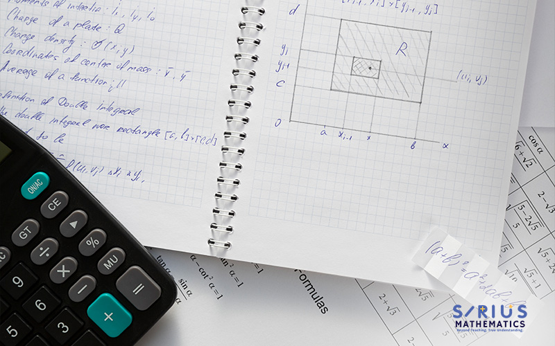 Math notebook and calculator for PSLE preparation.