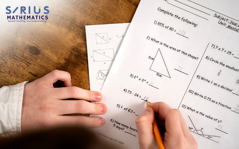 Sirius Mathematics student solving PSLE math questions on paper.
