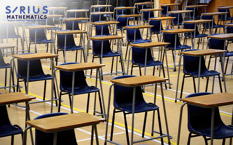 Empty school hall with exam desks and chairs