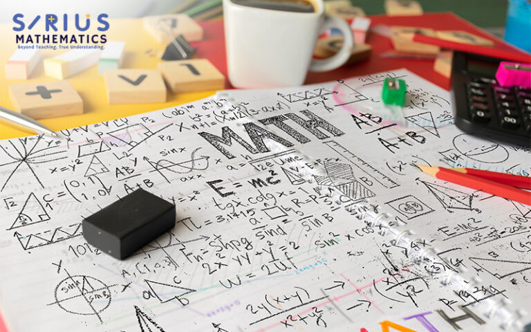 Math equations and figures on a messy desk.