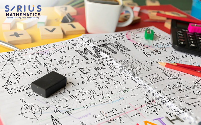 Math equations and figures on a messy desk.