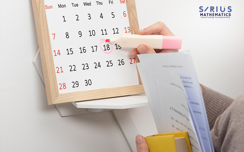 Person marking a calendar date for an E-Math mock exam