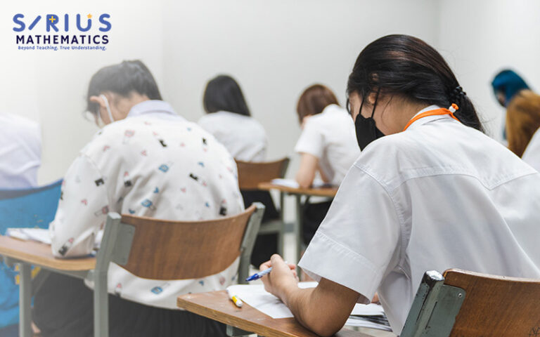 Student focused on an E-Maths exam paper.