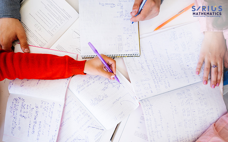 Students collaborating on complex A-Maths problems.