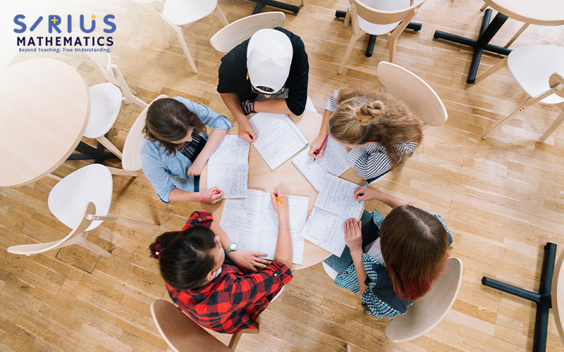 Students collaborating on E-Math problems at Sirius Mathematics.