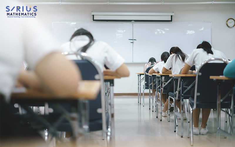 Primary school students taking a mathematics examination.