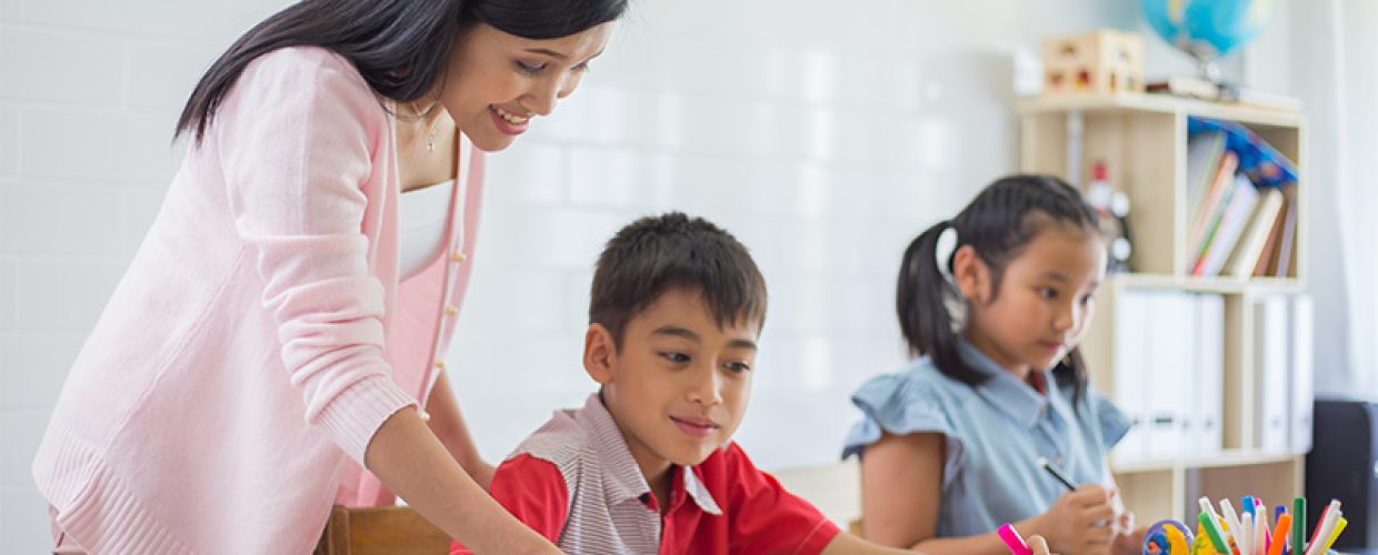 Teacher guiding students at Sirius Mathematics tuition.