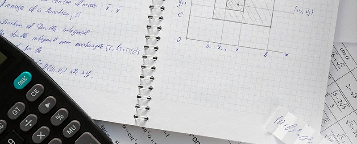 Math notebook and calculator for PSLE preparation.